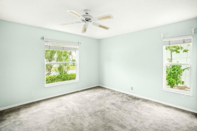 empty room with ceiling fan and carpet floors