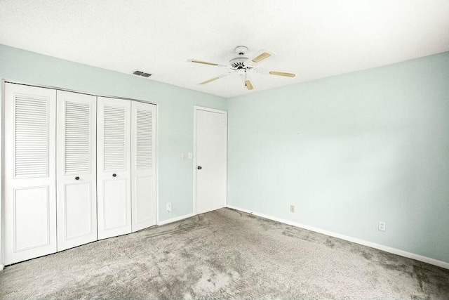 unfurnished bedroom featuring ceiling fan, carpet floors, and a closet