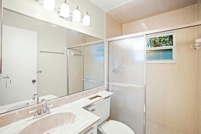 bathroom featuring vanity, toilet, and an enclosed shower