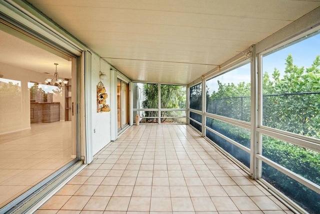 unfurnished sunroom featuring a notable chandelier