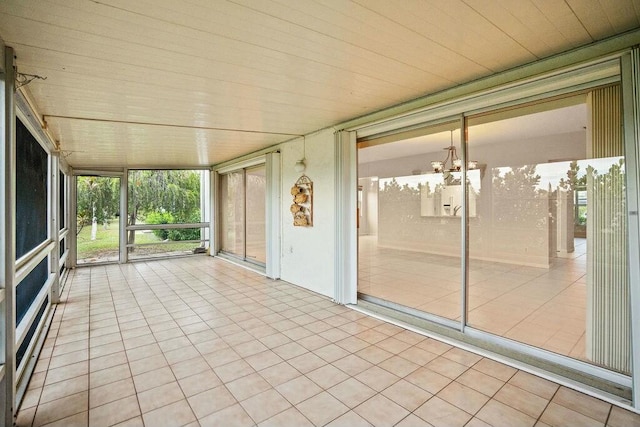 unfurnished sunroom with a chandelier and wood ceiling