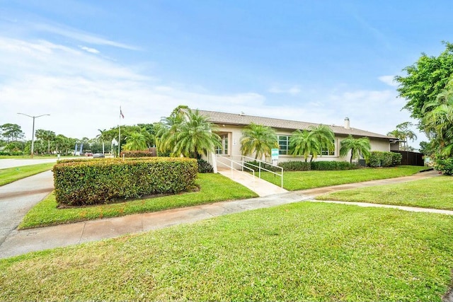 7410 Pine Forest Cir W, Lake Worth, FL 33467 - ranch-style home featuring a garage, stucco siding, driveway, and a front yard
