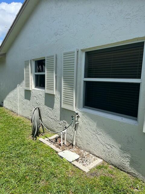 7410 Pine Forest Cir W, Lake Worth, FL 33467 - exterior space with a lawn and stucco siding