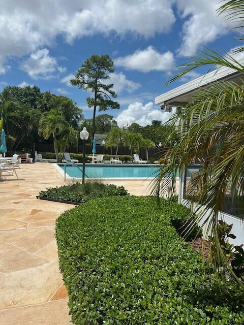 7410 Pine Forest Cir W, Lake Worth, FL 33467 - pool featuring fence and a patio area