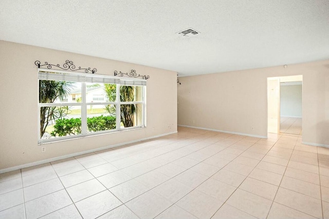 7410 Pine Forest Cir W, Lake Worth, FL 33467 - spare room featuring light tile patterned floors, baseboards, a textured ceiling, and visible vents