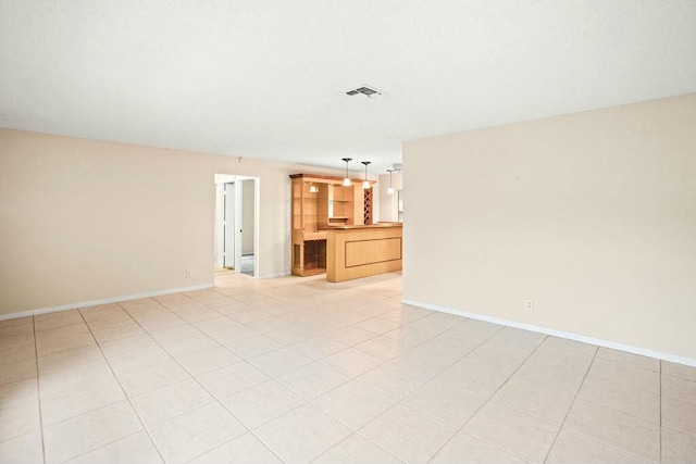 kitchen featuring light brown cabinets, white appliances, light tile patterned floors, and sink