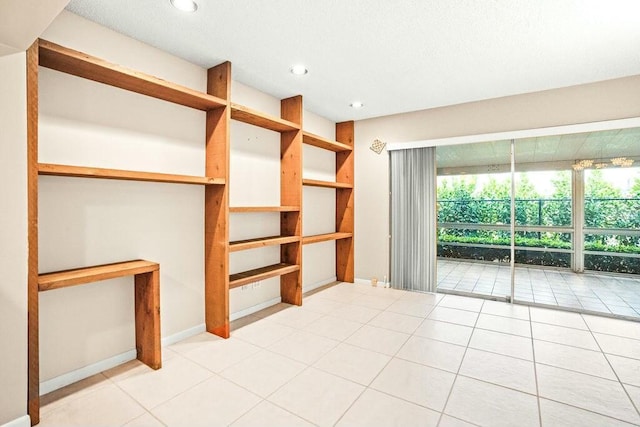 unfurnished living room featuring light tile patterned flooring