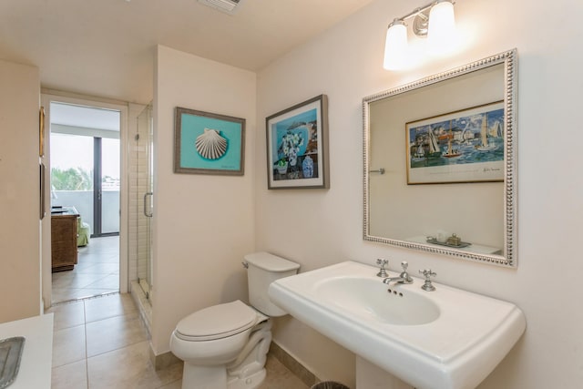 bathroom with tile patterned flooring, toilet, an enclosed shower, and sink