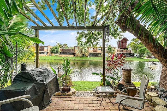 view of patio featuring a water view and a pergola