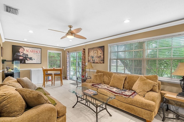 living room featuring ceiling fan, light tile patterned floors, and crown molding