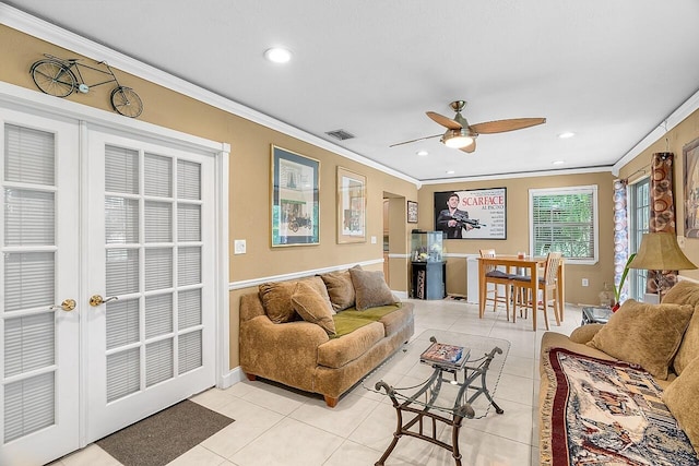 tiled living room with ceiling fan and ornamental molding