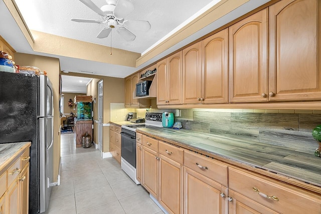 kitchen with white electric stove, backsplash, stainless steel fridge, a textured ceiling, and light tile patterned floors