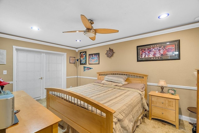 carpeted bedroom with ceiling fan and crown molding