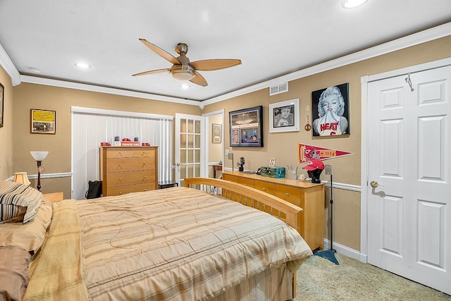 carpeted bedroom featuring ceiling fan and crown molding