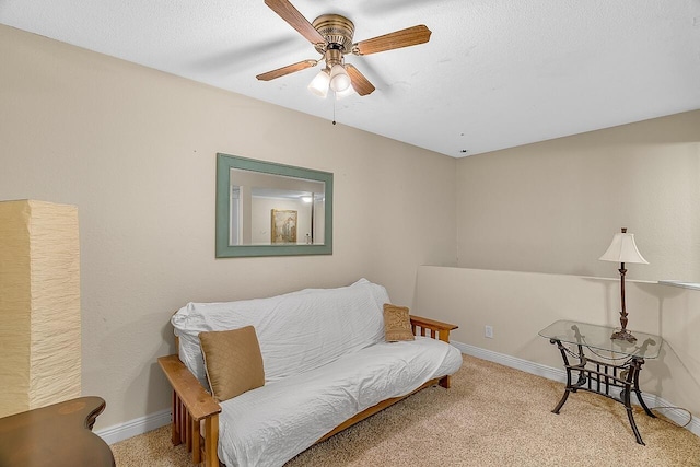 sitting room featuring light carpet and ceiling fan