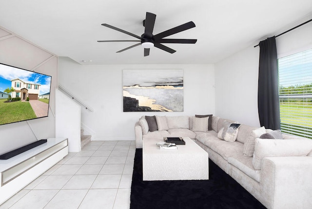 living room with ceiling fan and light tile patterned floors