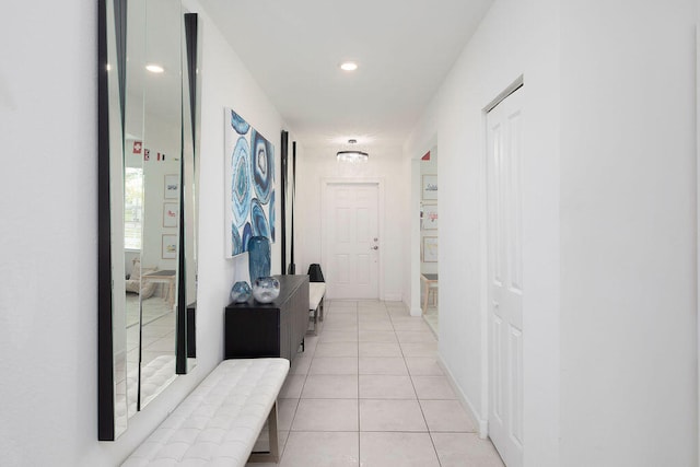 hall with light tile patterned floors