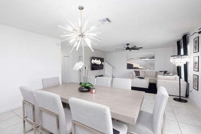 dining space with light tile patterned floors and ceiling fan with notable chandelier