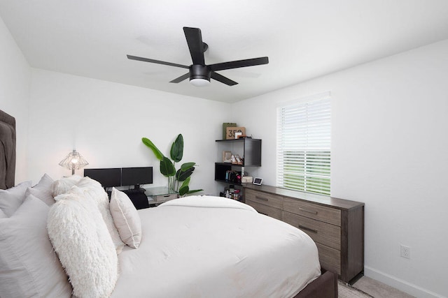 bedroom featuring ceiling fan and light colored carpet