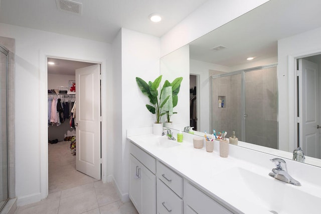 bathroom featuring tile patterned floors, vanity, and walk in shower