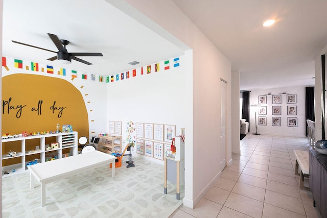 rec room with ceiling fan and light tile patterned flooring