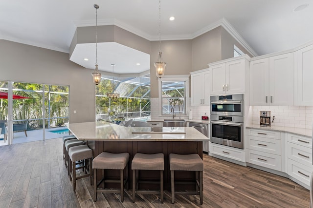 kitchen with plenty of natural light, white cabinets, and a kitchen island