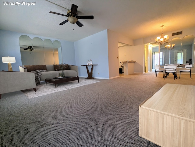 carpeted living room featuring ceiling fan with notable chandelier