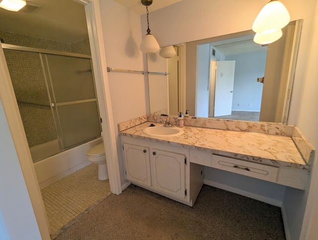 full bathroom featuring toilet, vanity, tile patterned flooring, and shower / bath combination with glass door