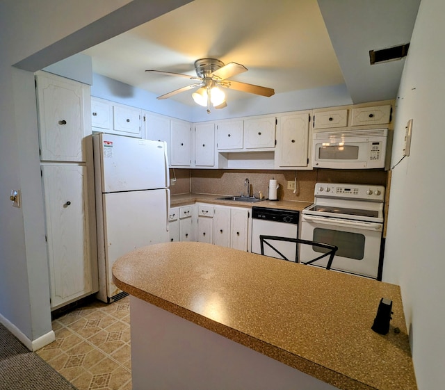 kitchen featuring sink, ceiling fan, light tile patterned floors, white appliances, and decorative backsplash