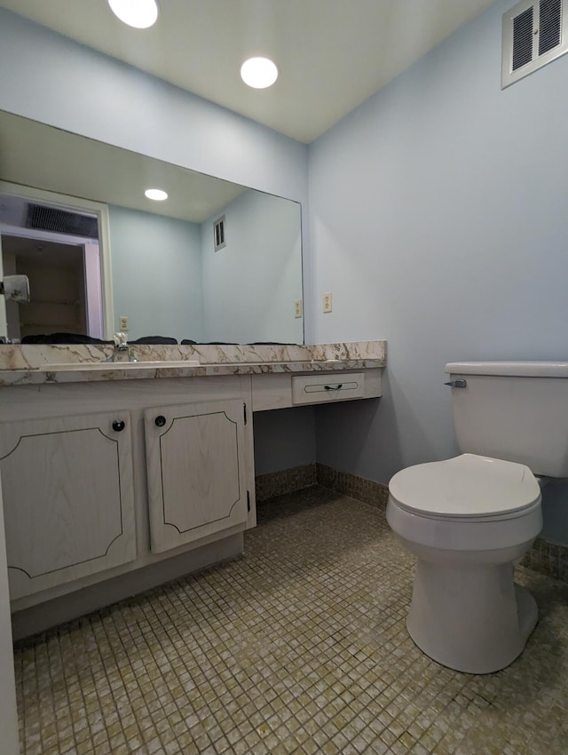 bathroom with toilet and vanity