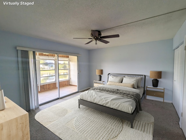 carpeted bedroom with ceiling fan, a textured ceiling, and a closet