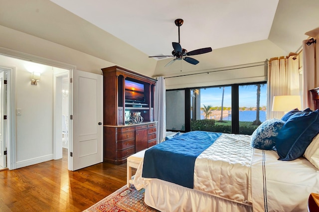 bedroom featuring ceiling fan, access to exterior, dark hardwood / wood-style flooring, and lofted ceiling