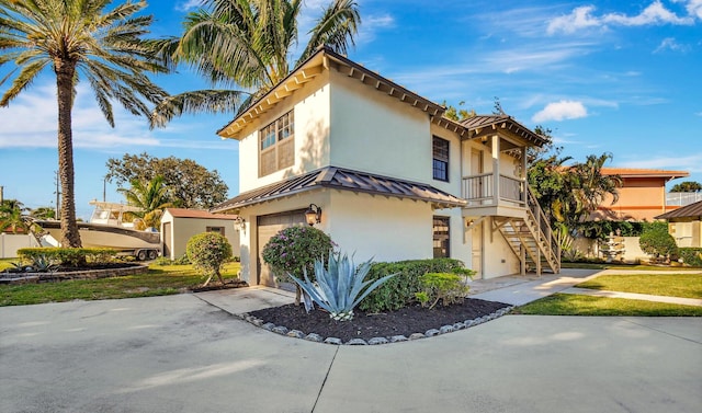 view of front of property with a garage and a balcony