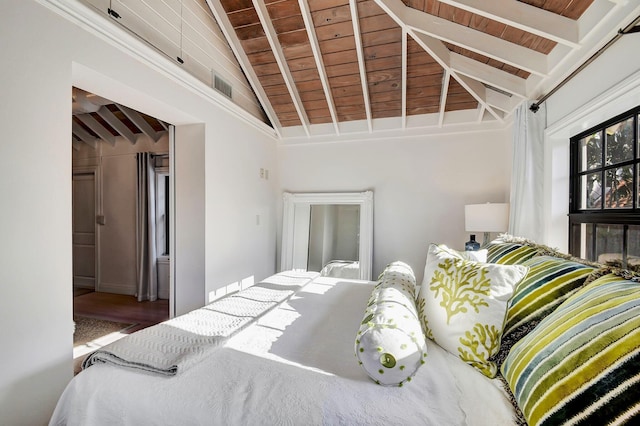 bedroom with vaulted ceiling with beams and wood ceiling