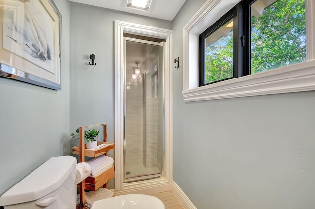 bathroom with tile patterned floors, toilet, and walk in shower