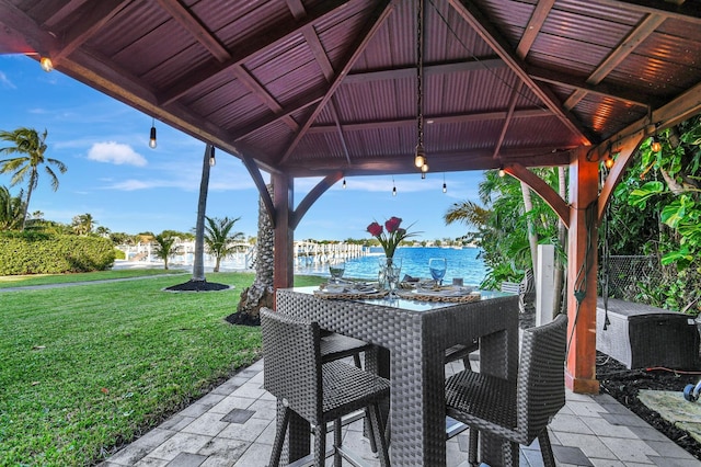 view of patio with a gazebo, a water view, and an outdoor bar