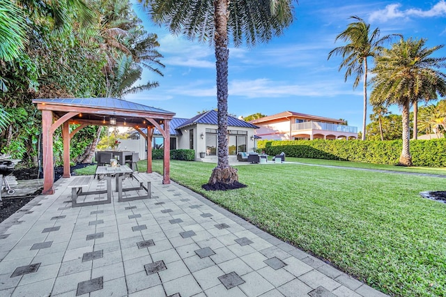 view of patio with an outbuilding and a gazebo