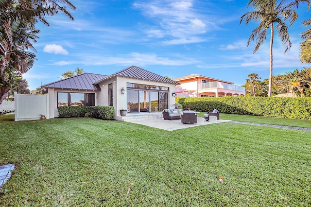 back of property featuring a yard, an outdoor living space, and a patio