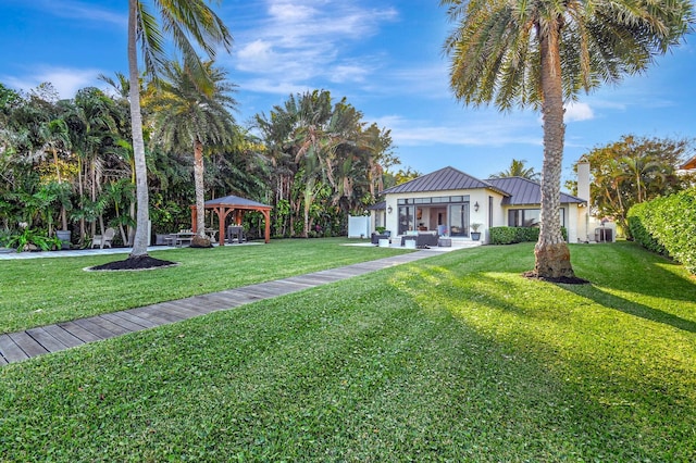 view of front of home with a front yard, a gazebo, and outdoor lounge area