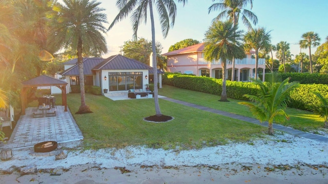 yard at dusk with a gazebo, an outdoor living space, and a patio