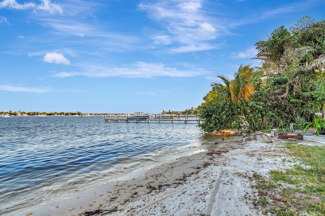 view of water feature featuring a boat dock and a beach view