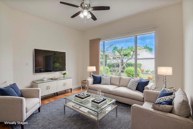 living room featuring hardwood / wood-style flooring and ceiling fan