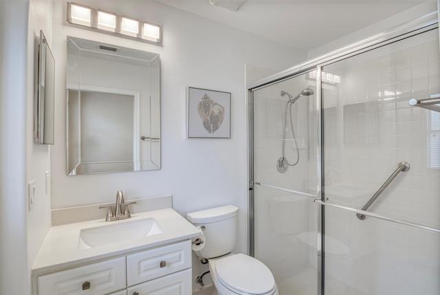 bathroom with vanity, toilet, and walk in shower