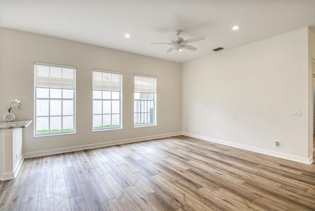 unfurnished room featuring light hardwood / wood-style flooring and ceiling fan