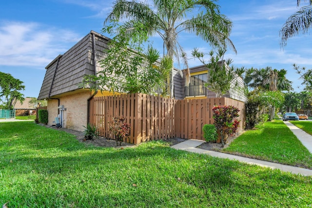 view of side of home with a yard