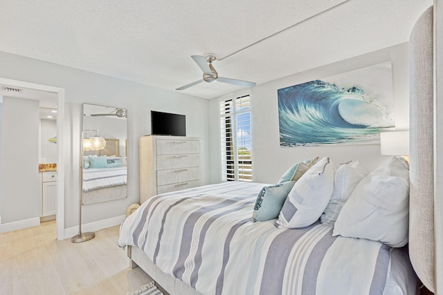 bedroom with ceiling fan, a textured ceiling, and light hardwood / wood-style flooring