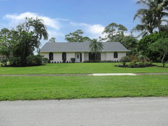 ranch-style home with a front yard