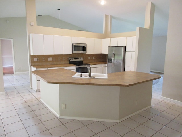 kitchen featuring tasteful backsplash, light tile patterned flooring, stainless steel appliances, white cabinetry, and high vaulted ceiling