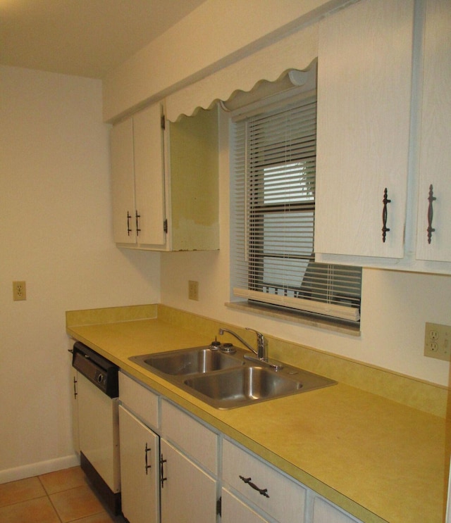 kitchen featuring light countertops, white dishwasher, a sink, and light tile patterned flooring