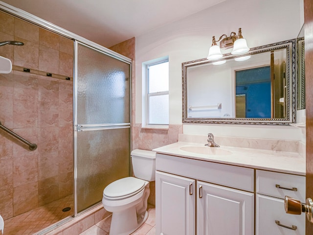 bathroom featuring toilet, vanity, tile patterned floors, and walk in shower